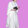 Elegant woman in white evening gown holding a clutch, bla bla.