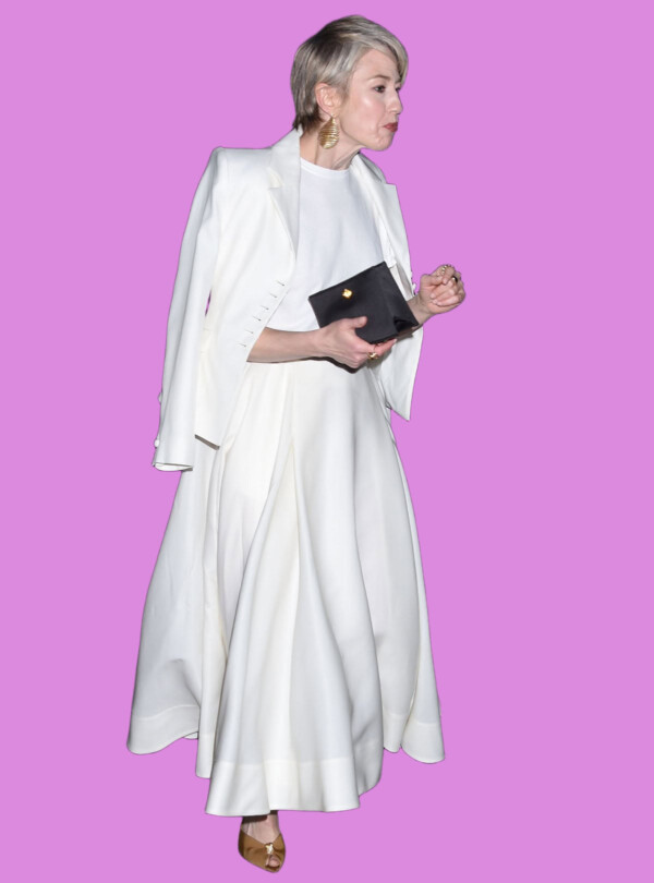 Elegant woman in white evening gown holding a clutch, bla bla.