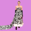 Fashion model wearing a strapless floral gown with long black gloves, standing against a purple background. bla bla.
