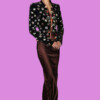 Fashionable woman in a black embroidered jacket and satin brown pants, bla bla.
