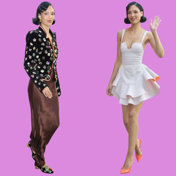 Two women standing against a purple background, one in a floral jacket and brown skirt, the other in a white dress waving, bla bla.